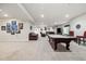 Large finished basement featuring a pool table, multiple seating areas, and ample space for entertaining at 23600 E Swallow Cir, Aurora, CO 80016