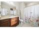 Well-maintained bathroom featuring a shower-tub combo, single sink vanity, and tile floors at 23600 E Swallow Cir, Aurora, CO 80016