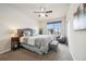 Well-lit bedroom with a comfortable bed, ceiling fan, and a large window overlooking the neighborhood at 23600 E Swallow Cir, Aurora, CO 80016