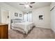 Cozy bedroom with carpeted floor, ceiling fan, neutral paint, and a view of the en-suite bathroom at 23600 E Swallow Cir, Aurora, CO 80016