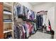 Organized walk-in closet with built-in shelving and hanging rods providing ample storage space at 23600 E Swallow Cir, Aurora, CO 80016