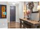 Foyer area with hardwood flooring, decorated with a wood table, lamp, and decorative mirror at 23600 E Swallow Cir, Aurora, CO 80016