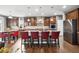 Well-appointed kitchen with counter seating, wooden cabinets, and stainless steel appliances at 23600 E Swallow Cir, Aurora, CO 80016
