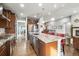 Spacious kitchen featuring a large granite island, stainless steel appliances, and hardwood floors at 23600 E Swallow Cir, Aurora, CO 80016