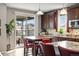 Bright eat-in kitchen with granite countertops, stainless steel appliances, and sliding glass door to patio at 23600 E Swallow Cir, Aurora, CO 80016