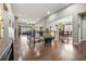 Open-concept living area and dining room, featuring beautiful hardwood floors and an open floorplan at 23600 E Swallow Cir, Aurora, CO 80016
