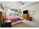 Comfortable main bedroom with a large window, ceiling fan, and neutral carpet at 23600 E Swallow Cir, Aurora, CO 80016