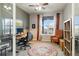 Home office with large window, ceiling fan, and built-in shelves and desk at 23600 E Swallow Cir, Aurora, CO 80016