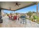 Covered outdoor patio featuring a ceiling fan, outdoor seating, and a clear sky view at 23600 E Swallow Cir, Aurora, CO 80016