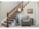 Carpeted staircase with decorative wrought iron railing and warm wood trim detail at 23600 E Swallow Cir, Aurora, CO 80016
