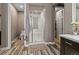 Bathroom featuring walk in shower, tile accent wall, toilet and tile floors at 14845 Haley Ave, Parker, CO 80134