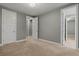 Neutral bedroom featuring carpeted floor, gray walls, white trim and multiple doors at 14845 Haley Ave, Parker, CO 80134