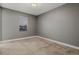 Neutral bedroom featuring carpeted floor, gray walls, white trim and window at 14845 Haley Ave, Parker, CO 80134