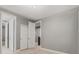 Neutral bedroom featuring carpeted floor, gray walls, white trim and multiple doors at 14845 Haley Ave, Parker, CO 80134