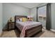 Bedroom with queen bed, wood furniture, and window with sunset view at 14845 Haley Ave, Parker, CO 80134