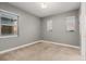 Empty bedroom with neutral walls, three windows, and carpeting at 14845 Haley Ave, Parker, CO 80134