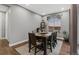 Dining room with wood table, rug, hardwood floors, and view to the outdoors at 14845 Haley Ave, Parker, CO 80134