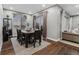 Dining room with seating for six, wood flooring, area rug, and sliding glass doors at 14845 Haley Ave, Parker, CO 80134