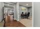 Hallway view showcasing hardwood floors, neutral paint, and access to a study at 14845 Haley Ave, Parker, CO 80134