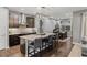 Modern kitchen featuring dark cabinets, granite countertops, and stainless steel appliances at 14845 Haley Ave, Parker, CO 80134