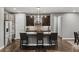 Modern kitchen featuring stainless steel appliances, a center island, and dark wood floors at 14845 Haley Ave, Parker, CO 80134