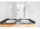 Bathroom featuring dual sinks, a large mirror, and modern fixtures for a functional and stylish space at 1780 N Washington St # 305, Denver, CO 80203