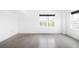 Sunlit bedroom showcasing concrete floors, neutral walls, and large windows that provide ample natural light at 1780 N Washington St # 305, Denver, CO 80203