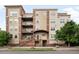 Multi-story condo building featuring brick accents, balconies and well-kept landscaping at 1780 N Washington St # 305, Denver, CO 80203