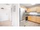 Well-lit kitchen featuring stainless steel appliances and light wood cabinets, complemented by tile flooring and a neutral color scheme at 1780 N Washington St # 305, Denver, CO 80203