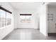 Inviting living room filled with natural light from large windows, showcasing concrete floors and neutral walls at 1780 N Washington St # 305, Denver, CO 80203