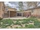 Brick home's backyard with patio and lawn at 2710 Zenobia St, Denver, CO 80212