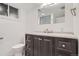Contemporary bathroom with dark wood vanity, granite countertop, and modern fixtures at 2710 Zenobia St, Denver, CO 80212