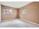 Bedroom with carpet, two windows for natural light, and neutral walls at 2710 Zenobia St, Denver, CO 80212