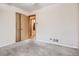 Cozy bedroom featuring a carpeted floor, adjacent closet, and view to the adjoining space at 2710 Zenobia St, Denver, CO 80212