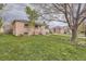 Brick home featuring a well-kept lawn with vibrant yellow wildflowers at 2710 Zenobia St, Denver, CO 80212