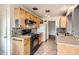 Functional kitchen with wooden cabinetry, updated appliances, and mosaic tile backsplash at 2710 Zenobia St, Denver, CO 80212