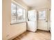 Laundry area with a stacked washer and dryer next to a door and window at 2710 Zenobia St, Denver, CO 80212