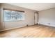 Light-filled living area with hardwood floors, a large window, and freshly painted neutral walls at 2710 Zenobia St, Denver, CO 80212