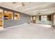 Spacious living room with hardwood floors and exposed wood beam ceiling, adjacent to the kitchen at 2710 Zenobia St, Denver, CO 80212