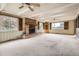 Spacious living room with a brick fireplace, wood beam ceiling, and large windows for ample natural light at 2710 Zenobia St, Denver, CO 80212
