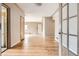 Bright hallway boasts beautiful hardwood floors and neutral walls, leading to a living room at 2710 Zenobia St, Denver, CO 80212
