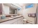 Well-lit bathroom featuring a large mirror, modern vanity, and neutral-toned decor at 463 Locust St, Denver, CO 80220
