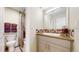 Bright bathroom featuring a granite countertop vanity, mirror and decorative tile backsplash at 463 Locust St, Denver, CO 80220