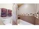 Bathroom featuring a tub and shower combination with tile walls and decorative tile accents at 463 Locust St, Denver, CO 80220
