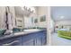 Bathroom featuring blue vanity with mosaic backsplash and view into a bedroom at 463 Locust St, Denver, CO 80220