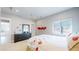 Bright bedroom featuring light gray walls, a modern dresser, and vibrant red wall shelves at 463 Locust St, Denver, CO 80220