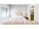 Cozy bedroom with a patterned duvet, bedside table with lamp, and an attached bathroom at 463 Locust St, Denver, CO 80220