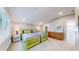 Bright bedroom featuring two twin beds with colorful decor, dresser, and vaulted ceilings at 463 Locust St, Denver, CO 80220