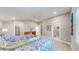 Bright bedroom featuring two twin beds with colorful bedding and a view of the ensuite bathroom at 463 Locust St, Denver, CO 80220