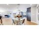 Open concept: dining area flows to a kitchen with an island bar, and modern cabinets at 463 Locust St, Denver, CO 80220